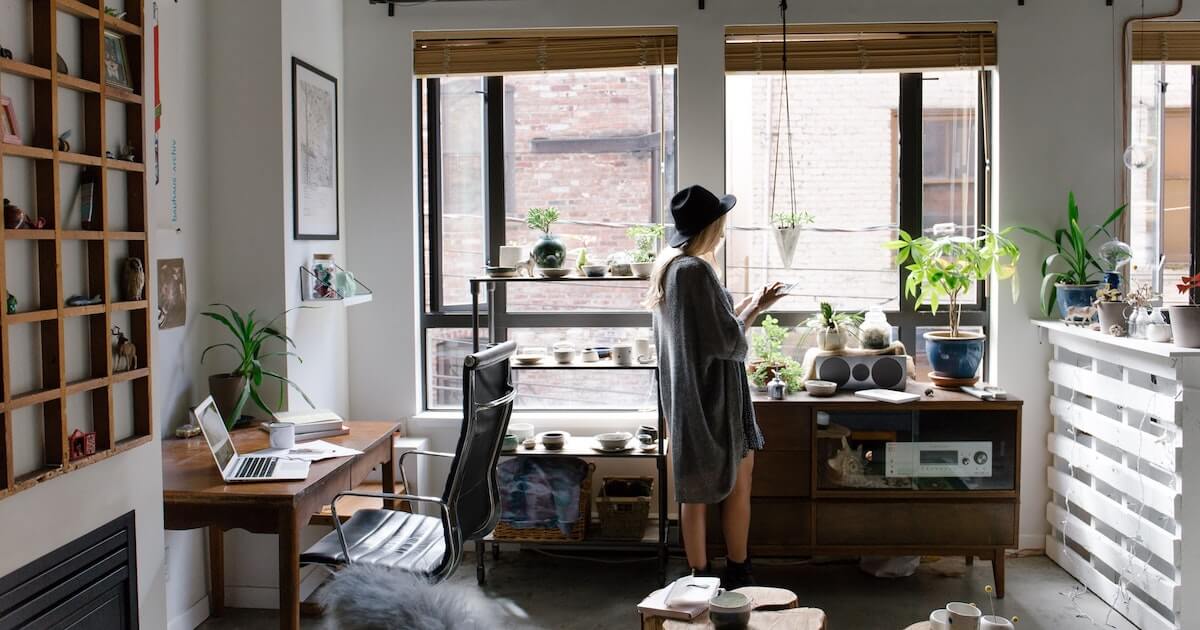 A tenant looking from the window of her trendy apartment.